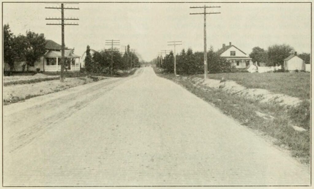 A Brick-Paved Road with Dirt Road Alongside